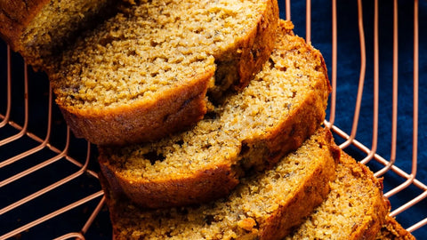 Sliced banana bread cooling on a wire rack with a rich golden crust and moist texture, ideal for dessert or breakfast.