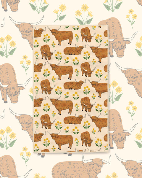 Highland Cows Kitchen & Tea Towel with brown Highland cows among yellow flowers on cream