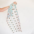 Honey Bee Kitchen & Tea Towel held up, showcasing vibrant bee patterns on eco-friendly fabric.