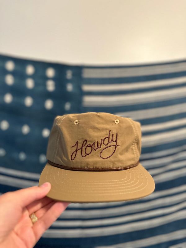 Howdy Hat in hand, showcasing the embroidered design, perfect for festivals and road trips.
