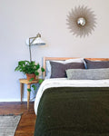 Cozy bedroom setup featuring a Humboldt Blanket on the bed with earthy tones and natural textures.