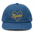 Blue denim cap with yellow "Kiddo" embroidery in heart design, perfect for stylish kids' fashion.