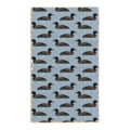Loons dish towel featuring loon birds in black on blue water-inspired background with geometric wave patterns throughout