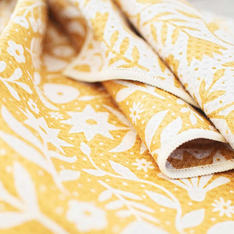 Yellow floral pattern on Meadow Kitchen & Tea Towel made from 100% recycled, super absorbent, quick-drying fabric.