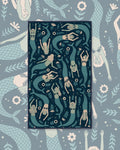 Mermaids Kitchen & Tea Towel with swimming mermaids in sage and cream on a dark navy background
