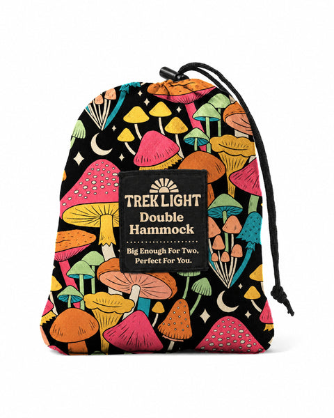 Double Hammock in Midnight Mushroom Print, a black drawstring stuff sack covered in colorful mushrooms and moons, on white
