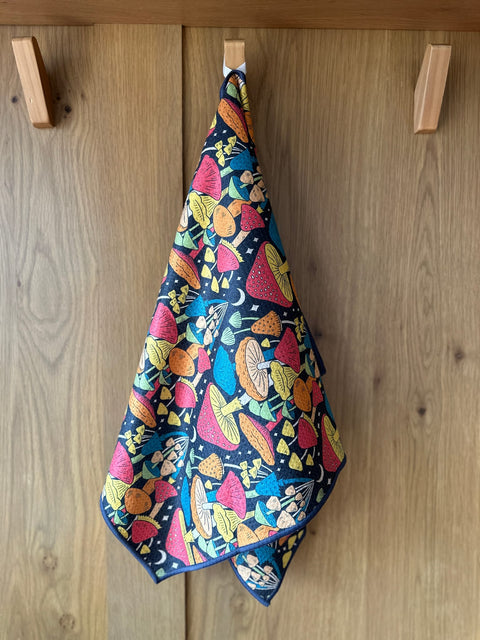 Midnight Mushroom Kitchen & Tea Towel hanging, showcasing vibrant double-sided design with eco-friendly, super absorbent Grip-Tex™ fabric.