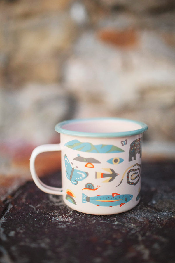 Mountain Stream Enamel Mug 16oz with colorful nature motifs, perfect for outdoor adventures or cozy mornings at home.
