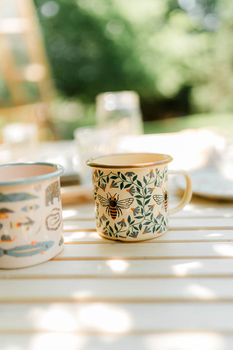Honey Bee Enamel Mug 16oz featuring a vintage design with bees and leaves, perfect for cozy mornings and camping.
