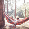 Double Hammock & Pro Hanging Straps (Midnight Mushroom Print) in use with children in a forest setting.