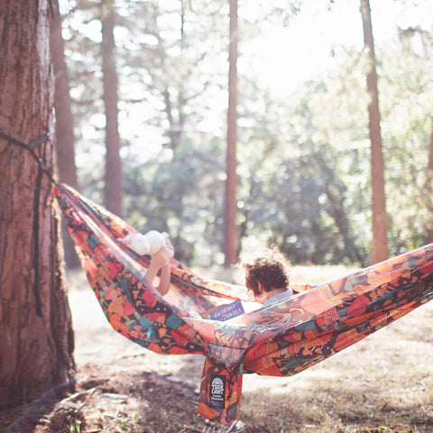 Double Hammock & Pro Hanging Straps (Midnight Mushroom Print) in use with children in a forest setting.