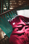 Cozy Napa Blanket draped over a green hammock, perfect for relaxation and outdoor enjoyment.