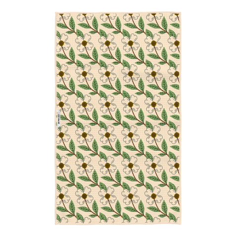North Carolina tea towel with repeating pattern of white dogwood flowers and green leaves throughout