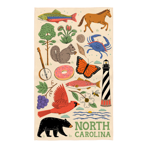 North Carolina kitchen towel with colorful illustrations of fish, horse, bear, butterfly, lighthouse, and wildflowers on cream background