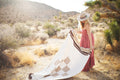 Beautiful handwoven North Star blanket in a desert setting, made from recycled clothing materials, showcasing its cozy versatility. By Trek Light.