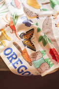 Vibrant Oregon Kitchen & Tea Towel featuring colorful designs of nature and wildlife, perfect for everyday use.