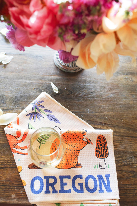 Oregon Kitchen & Tea Towel featuring designs of wildlife and plants, perfect for PNW pride and kitchen use.
