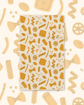 Pasta Time Kitchen & Tea Towel with golden pasta shapes on a cream background
