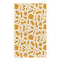 Pasta Time kitchen tea towel with orange illustrated pasta shapes including farfalle, rigatoni, and wheels on cream