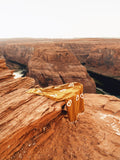 Peace Blanket draped on a rock ledge overlooking a canyon, embodying cozy comfort and peace.