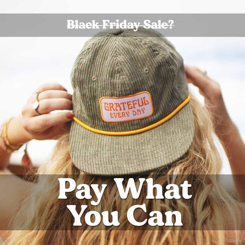Person wearing a hat with 'Grateful Every Day' patch, promoting a Black Friday Sale with 'Pay What You Can' offer.