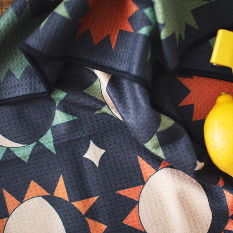 Moon Phase Kitchen & Tea Towel featuring vibrant double-sided design with sun and moon motifs, eco-friendly, super absorbent fabric.