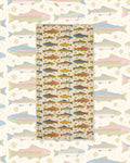 River Trout Wander & Travel Towel in cream with colorful trout and stars, on a matching larger fish print.