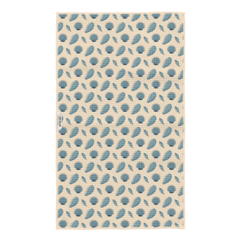 Reverse side of Salty Seas kitchen tea towel with blue scallop shell, oyster and clam pattern on cream, Trek Light logo tag