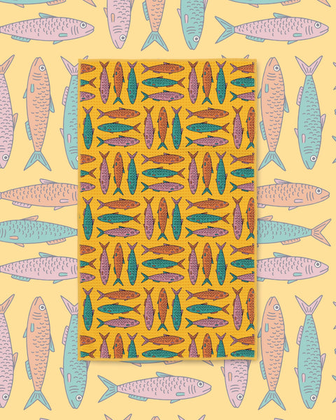 Sardine School Kitchen & Tea Towel with rows of teal and orange sardines on a golden yellow background