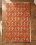 Skeleton Party waffle kitchen tea towel laid flat on a wood counter showing the full front print