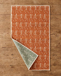 Skeleton Party waffle kitchen tea towel flat lay with a corner folded up to reveal the reverse print