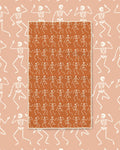 Skeleton Party Kitchen & Tea Towel with rows of white dancing skeletons on an orange background