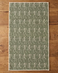 Skeleton Party waffle kitchen tea towel reverse side laid flat: sage-green with cream dancing skeletons
