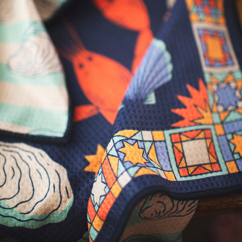 Colorful Snug Harbor Kitchen & Tea Towel with vibrant patterns, eco-friendly and super absorbent design for effective cleaning.