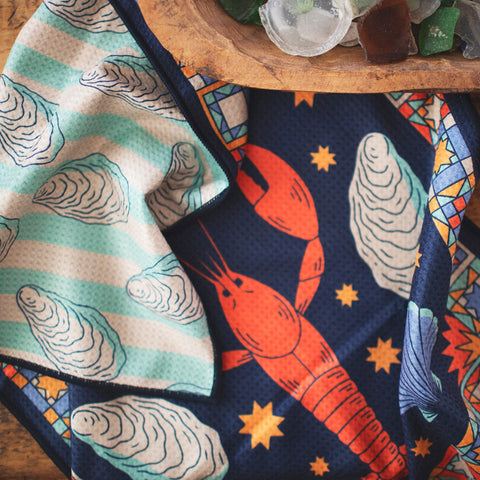 Snug Harbor Kitchen & Tea Towel with vibrant double-sided design featuring a colorful lobster and oyster pattern, eco-friendly fabric.