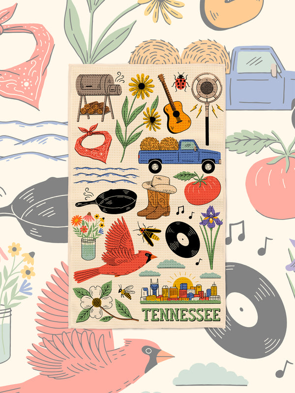 Tennessee microfiber towel styled on a matching illustrated backdrop of hay bales, blue truck, cast iron pan and bandana