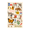 Texas-themed design on a kitchen towel, featuring Texas flag, armadillo, cowboy gear, and more. "Texas Kitchen & Tea Towel" collection.