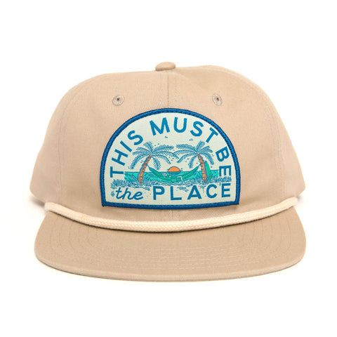 Trek Light 6-panel snapback hat with 'This Must Be The Place' design, perfect for beach adventures. Stylish, breathable, flat brim.