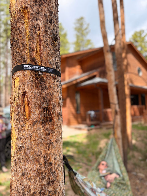 Tree strap from the Double Hammock & Pro Hanging Straps (River Trout Print) securely attached to a tree.