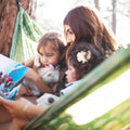 Woman and two children reading together in a Double Hammock & Pro Hanging Straps (River Trout Print).