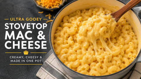 Creamy stovetop mac and cheese in a pot with a wooden spoon, showcasing ultra gooey texture and cheese.