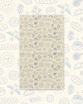Wake & Bakery Kitchen & Tea Towel with blue line-drawn breads, pastries and suns on a tan background
