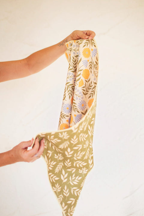 Wavy Flowers Kitchen & Tea Towel displayed with double-sided floral design and vibrant colors, perfect for retro kitchen vibes.