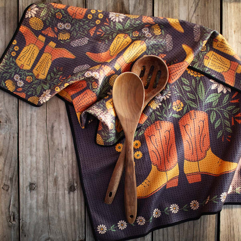 Western Bloom kitchen and tea towel featuring vibrant designs, eco-friendly fabric, with wooden spoons on rustic surface. Perfect for drying dishes.
