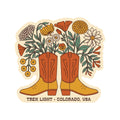 Western Bloom Sticker featuring boots filled with flowers, made in the USA, waterproof and UV resistant vinyl, 2.7" x 2.54".