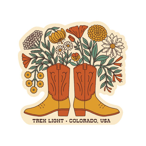 Western Bloom Sticker featuring boots filled with flowers, made in the USA, waterproof and UV resistant vinyl, 2.7" x 2.54".
