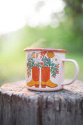 Western Bloom enamel mug 16oz with floral boot design, perfect for adventures. Durable and delightful, by Trek Light.