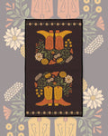 Western Bloom Kitchen & Tea Towel with orange cowboy boots and wildflower bouquets on a dark brown background