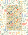 Wildflower Wonder Kitchen & Tea Towel with a meadow of red poppies, blue lupines and yellow wildflowers on cream