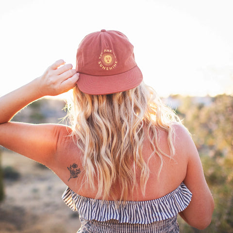 You Are My Sunshine Hat worn by a woman in a sunny outdoor setting, highlighting comfort and style.